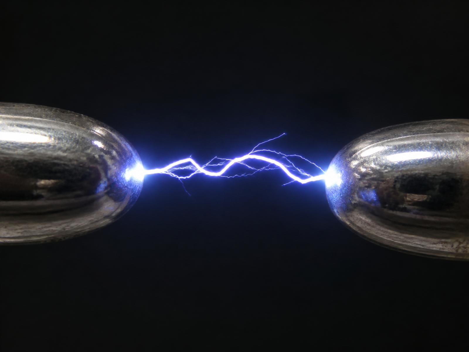 Close-up of an electrostatic discharge spark between two metal contacts